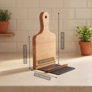 a wooden cutting board with measurements and a potted plant on a kitchen counter.