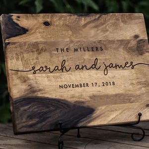 a wooden sign with a couple's names on it
