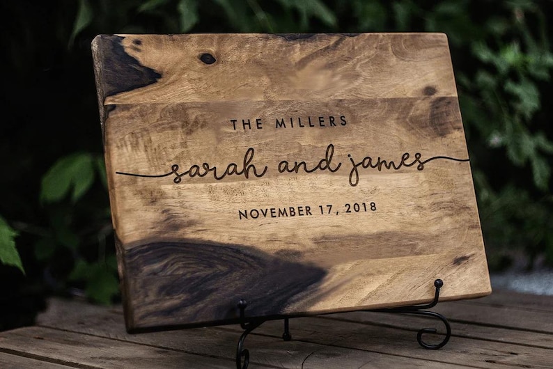 a wooden sign with a couple's names on it