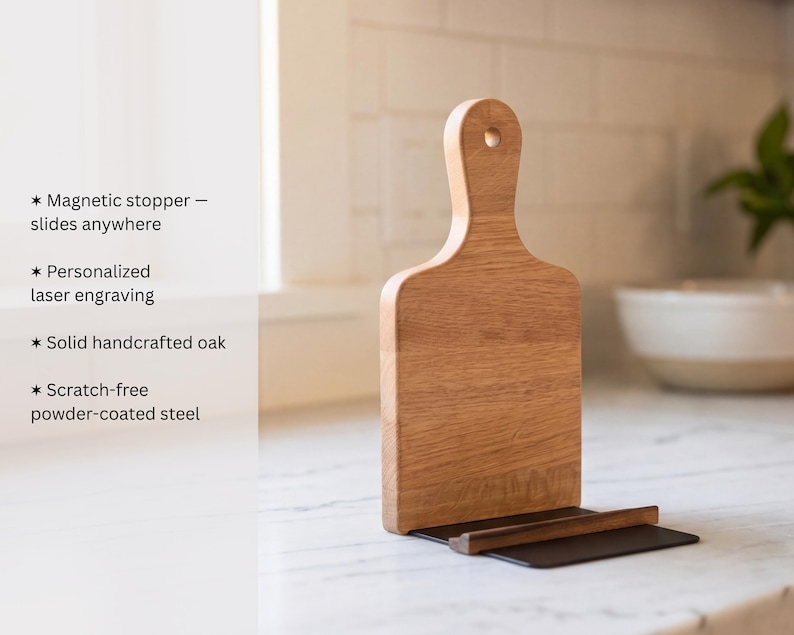 a wooden cutting board with a black handle, placed on a white countertop.