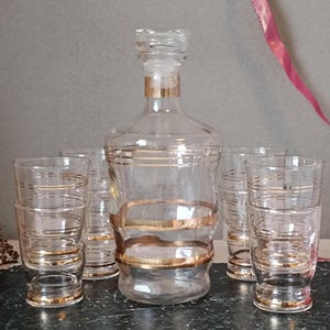 French antique drinking set, 8 shot glasses & decanter with stopper with golden line decor