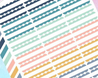 May include: A sheet of colorful scalloped border stickers. The stickers are in shades of blue, green, pink, and yellow. The stickers are arranged in rows and columns.