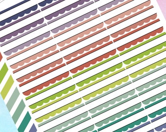 May include: A sheet of colorful washi tape with scalloped edges. The tape is arranged in rows, with each row featuring a different color. The colors include purple, pink, red, green, blue, and teal.