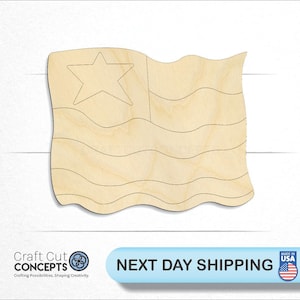 May include: A wooden cutout of a wavy American flag with a single star in the blue corner. The flag is unpainted and ready to be decorated.