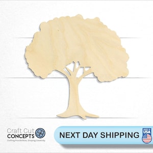 May include: A wooden tree cutout with a detailed trunk and leafy crown. The tree is made of light-colored wood and is set against a white background. The image includes the text "Craft Cut Concepts" and "Made in USA".