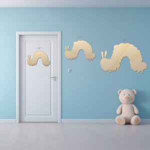 Caterpillar shape sign shapes on a door and wall to view the scale.