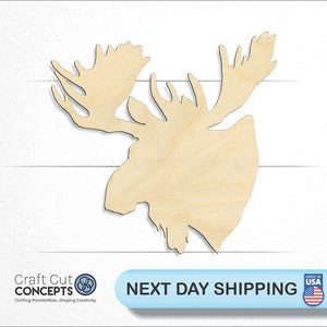 May include: Wooden cutout of a moose head with large antlers. The cutout is unpainted and has a natural wood color.