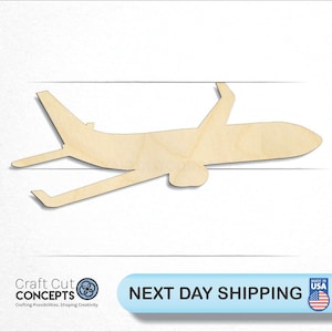 May include: A wooden cutout of an airplane in flight. The airplane is made of light brown wood and is in a simple silhouette style.