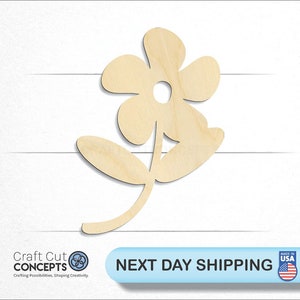 May include: A simple wooden cutout of a flower with five petals and a stem with two leaves. The flower is light brown and the cutout is against a white background.