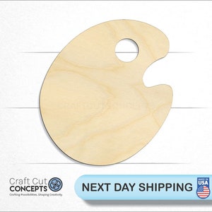 May include: A wooden paint palette with a round hole in the center. The palette is made of light-colored wood and is shaped like a traditional artist's palette.