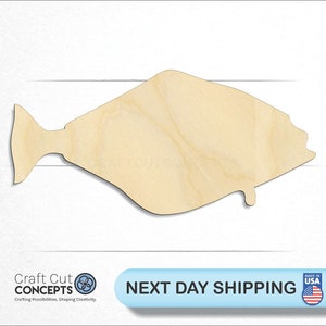 May include: A wooden cutout of a halibut fish. The cutout is unpainted and has a natural wood color.