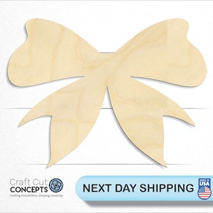 May include: A large, unfinished wooden bow shape. The bow is made of natural wood and has a smooth surface. It is perfect for crafting and decorating.