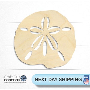 May include: A wooden cutout of a sand dollar, a common seashell found on beaches. The cutout is made of natural wood and has a light brown color.