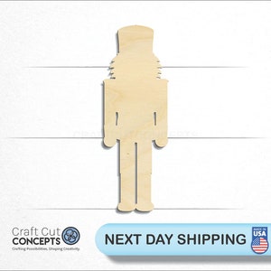 May include: A wooden cutout of a nutcracker, a traditional Christmas decoration. The cutout is unpainted and ready to be decorated.