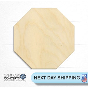 May include: A natural wood octagon shape, perfect for crafting projects.  The wood is light brown with a smooth surface.