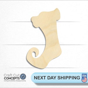 May include: A wooden cutout of a Christmas stocking with a curled toe. The stocking is unpainted and ready to be decorated.