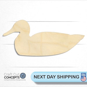 May include: A wooden cutout of a duck in a natural wood color. The duck is facing to the right and has a long beak. The cutout is a simple shape with no details.