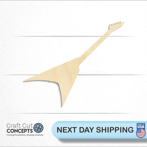 May include: A wooden cutout of a guitar in the shape of a flying V. The guitar is light brown and has a simple design.