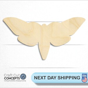 May include: A wooden cutout of a butterfly in a light brown color. The butterfly is in a flying position with its wings spread out.