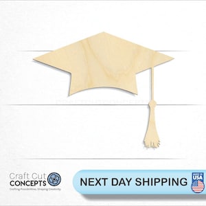 May include: A wooden cutout of a graduation cap with a tassel. The cap is light brown and the tassel is a darker brown. The cutout is perfect for crafting projects or decorations.
