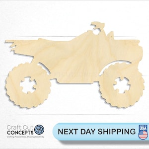 May include: A wooden cutout of an ATV, a four-wheeled all-terrain vehicle, in a natural wood color. The ATV is facing to the right and has a simple design.