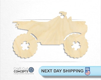 May include: A wooden cutout of an ATV, a four-wheeled all-terrain vehicle, in a natural wood color. The ATV is facing to the right and has a simple design.