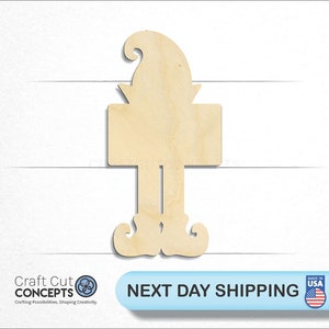 May include: A wooden cutout in the shape of a gnome, featuring a pointed hat, a rectangular sign, and curled shoes. The sign is blank, ready for customization. The text "Craft Cut Concepts" is visible in the lower left corner.