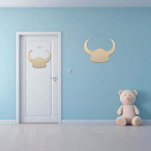 Vikings Norse Helmet Shape sign shapes on a door and wall to view the scale.