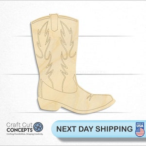 May include: A wooden cutout of a cowboy boot with a decorative design. The boot is light brown and has a pointed toe.