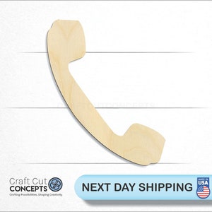 May include: A wooden cutout of a vintage rotary phone receiver. The cutout is unpainted and has a natural wood finish.