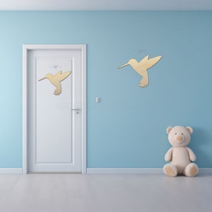 Hummingbird Craft Shape sign shapes on a door and wall to view the scale.