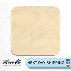 May include: A square piece of unfinished wood with rounded corners. The wood is light brown in color and has a natural grain pattern.