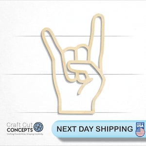 May include: A wooden cutout of a hand making the rock and roll hand gesture. The cutout is light brown and has a simple line drawing style.