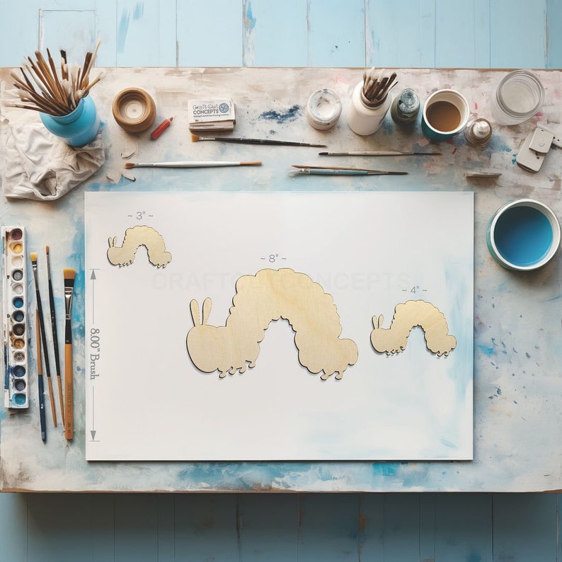 Caterpillar shape Craft blanks next to paint brush showing scale