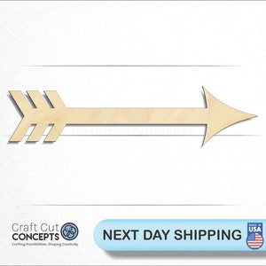 May include: A wooden arrow shape with a pointed tip and three lines at the back of the arrow. The arrow is light brown in color.