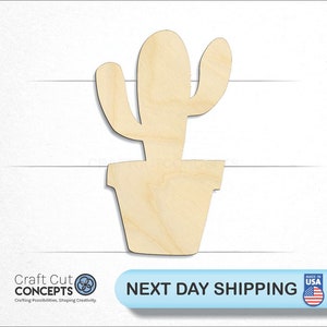 May include: A wooden cutout of a cactus in a pot. The cactus is light brown and has a simple design. The pot is also light brown and has a rounded shape.