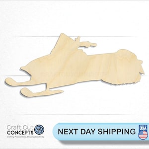 May include: A wooden cutout of a snowmobile, a winter vehicle used for traveling on snow. The cutout is unpainted and ready to be decorated.