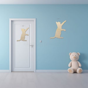 Playful Playing Cat Shape sign shapes on a door and wall to view the scale.