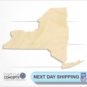 May include: A wooden cutout of the state of New York. The cutout is light brown and has a smooth surface. The cutout is on a white background.