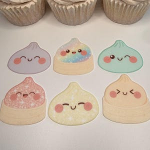 May include: Three cupcakes with beige frosting are positioned above six flat, sticker-like illustrations of dumplings. The dumplings feature various pastel colors, glittery textures, and simple, happy facial expressions with rosy cheeks.