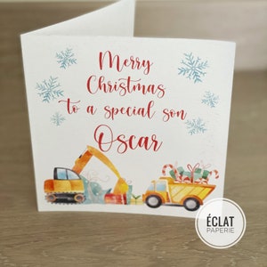 May include: A Christmas card with a red and white "Merry Christmas to a special son Oscar" message. The card features a yellow toy dumper truck and excavator with Christmas presents and candy canes.