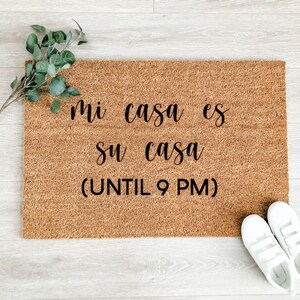 May include: A brown coir doormat with the text "mi casa es su casa (UNTIL 9 PM)" in black lettering.
