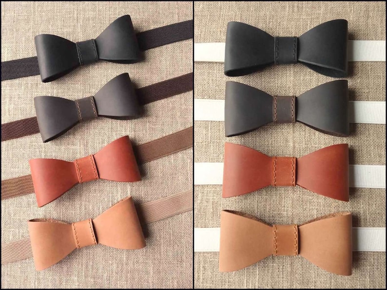 May include: A collection of leather bow ties in various shades of black, brown, and tan. Each bow tie is meticulously crafted with a stitched center band and attached to an elastic strap. The bow ties are displayed on a neutral background.