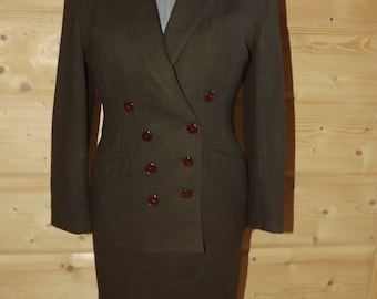 May include: A dark brown double-breasted blazer and skirt suit. The suit has a classic tailored fit and features a skirt that falls just above the knee.