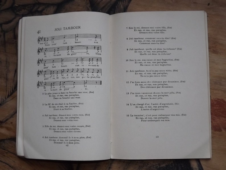 May include: A vintage French children's book titled "Joli Tambour" with a musical score and lyrics. The book is open to pages 41 and 43, showing the lyrics for the song "Joli Tambour".