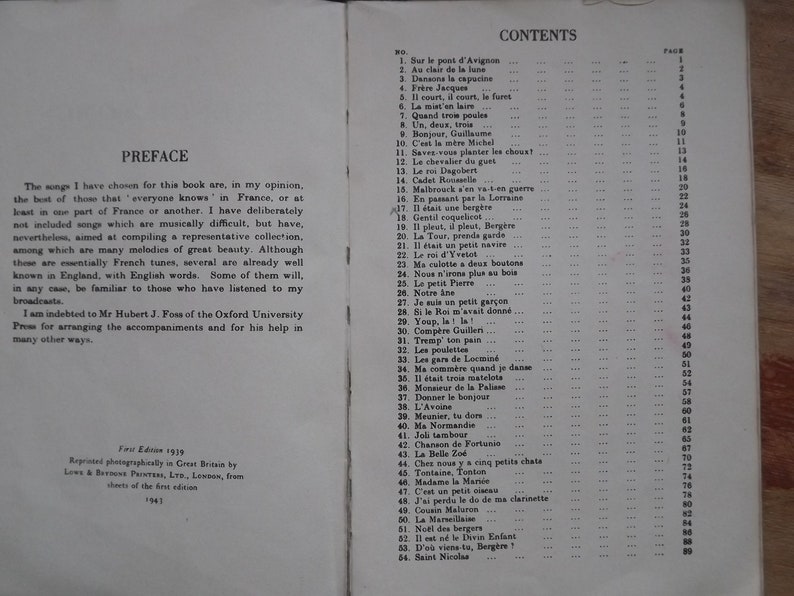 May include: A black and white book with the title "French Folk Songs" and a table of contents listing song titles and page numbers.