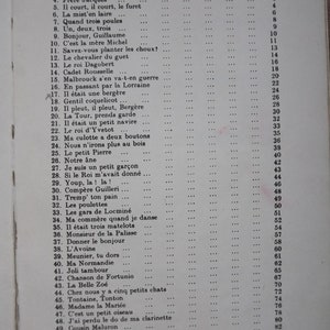 May include: A black and white book with the title "CONTENTS" printed in bold at the top of the page. The book lists a table of contents with song titles and page numbers. The song titles are in French.