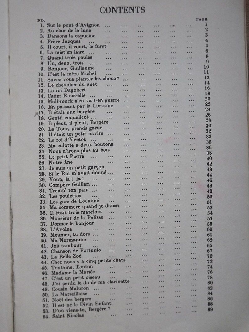May include: A black and white book with the title "CONTENTS" printed in bold at the top of the page. The book lists a table of contents with song titles and page numbers. The song titles are in French.