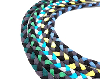 May include: A set of six braided cords in various colors, including black, gray, green, blue, and yellow. The cords are braided together in a decorative pattern.