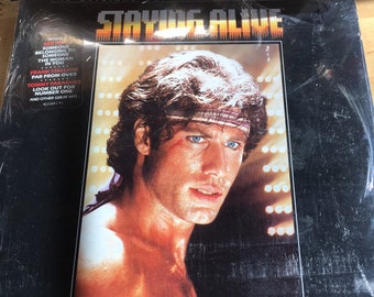 Staying Alive. The Original motion picture soundtrack.  Unopened in the same package Flashdance, the original motion picture soundtrack.